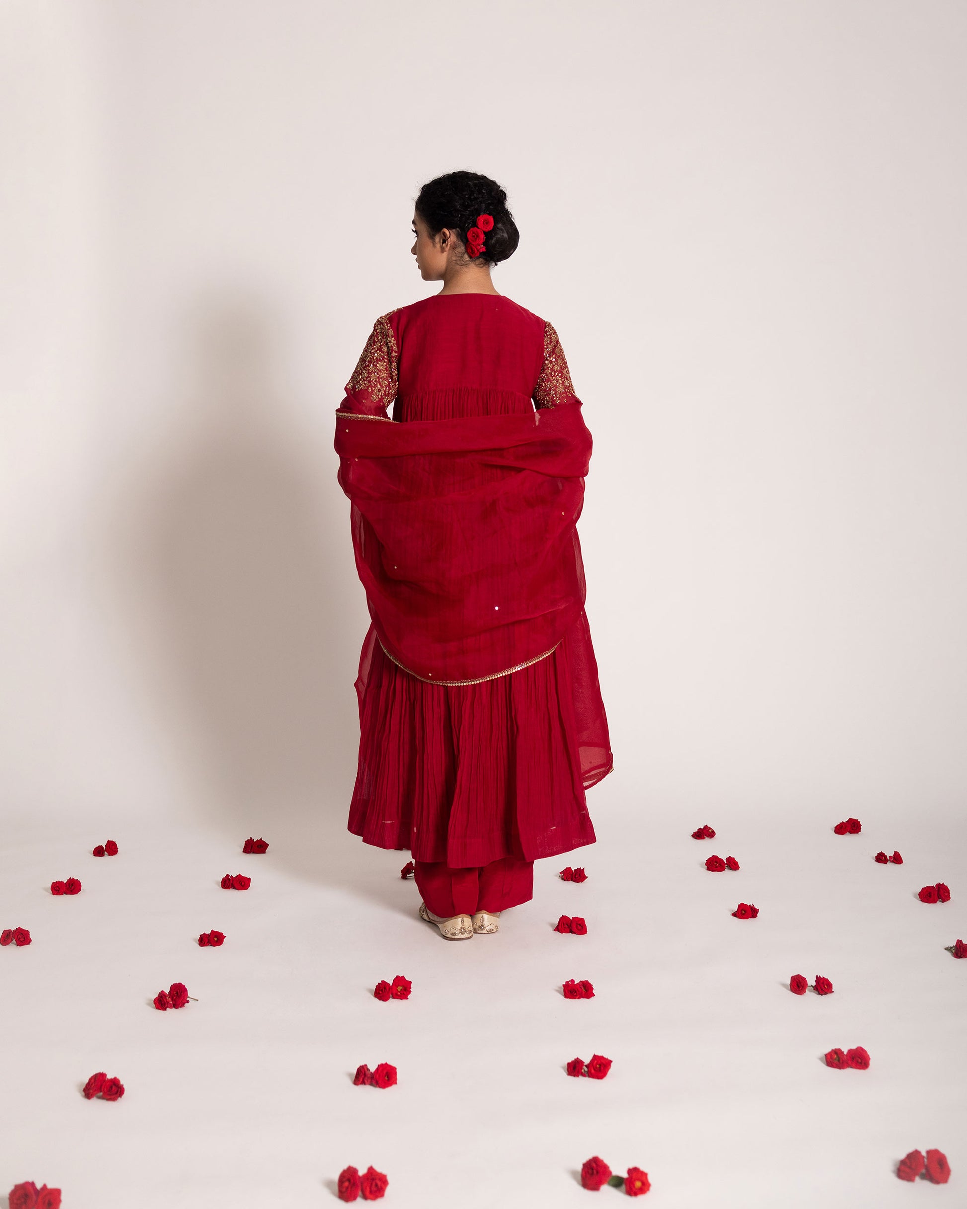Red gathered salwar set with vibrant festive charm and flowing elegance, designed for a bold and timeless ethnic statement.