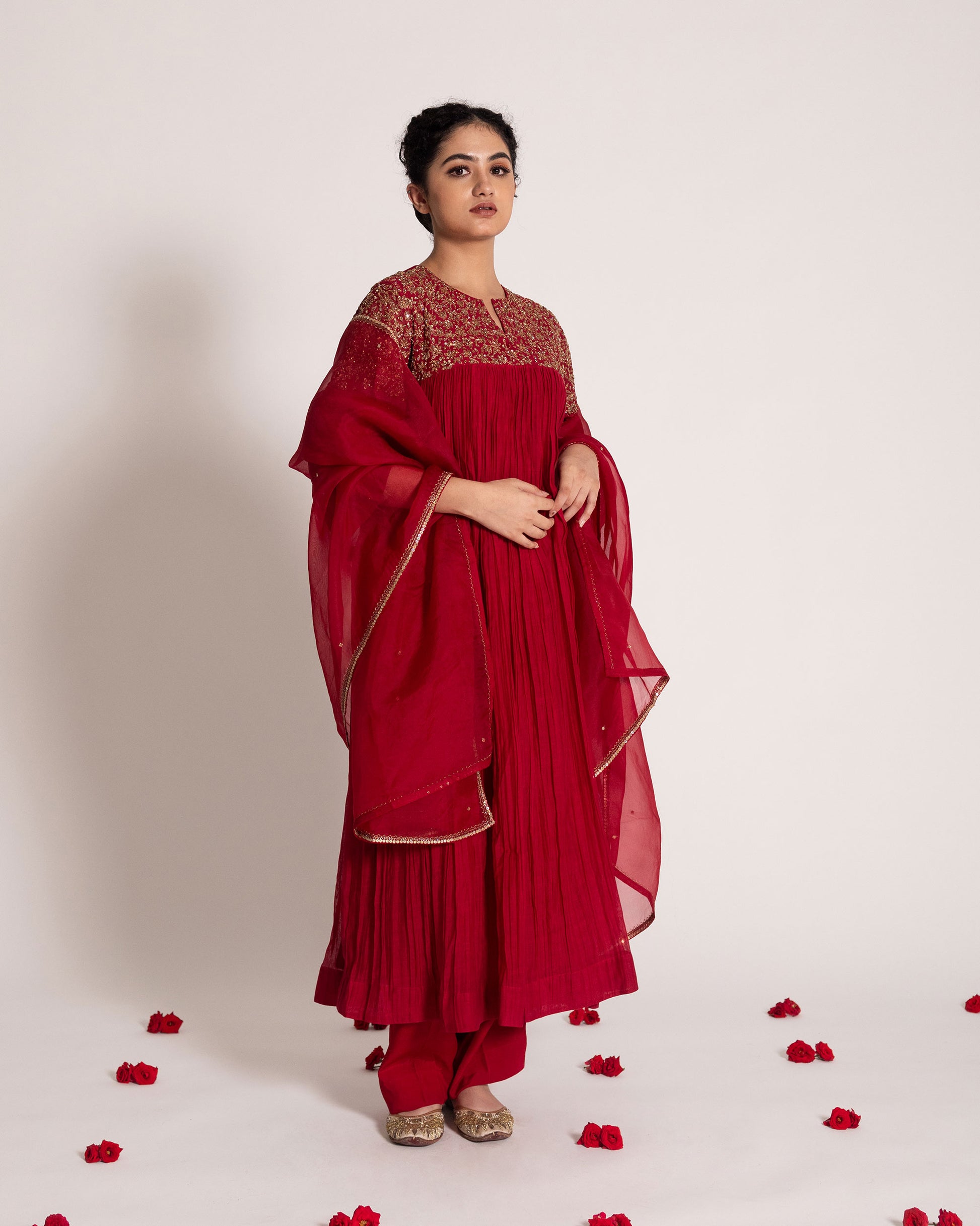 Red gathered salwar set with vibrant festive charm and flowing elegance, designed for a bold and timeless ethnic statement.