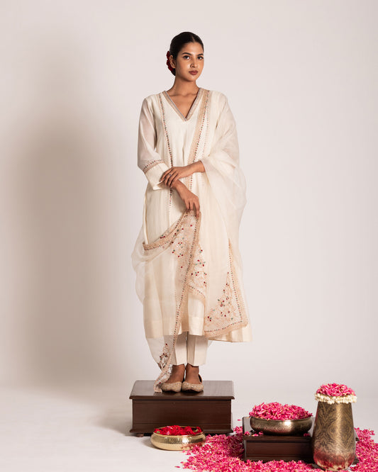 Pearl white salwar set with pristine elegance and timeless charm, crafted for a graceful and sophisticated ethnic look.