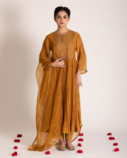 Burnt yellow salwar set with warm earthy tones and elegant styling, crafted for a radiant and timeless ethnic look.