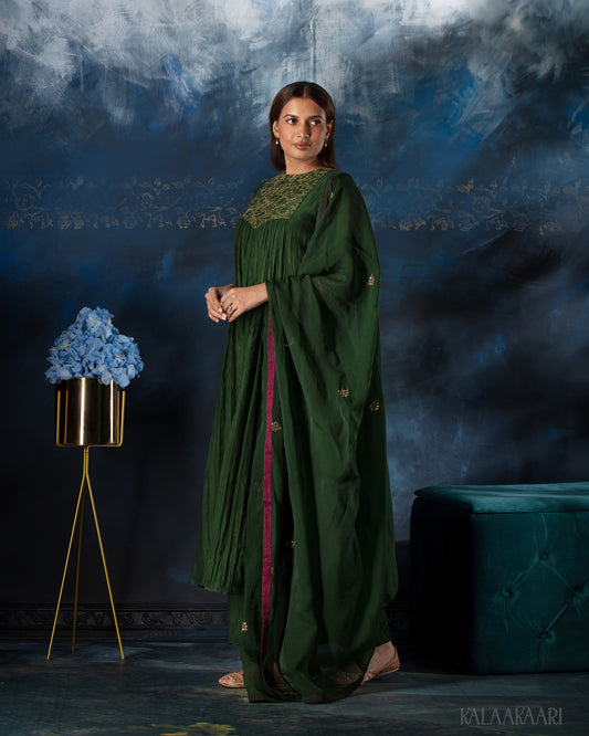 Dark green hand embroidered salwar set with intricate craftsmanship and rich detailing, offering a sophisticated blend of tradition and elegance.